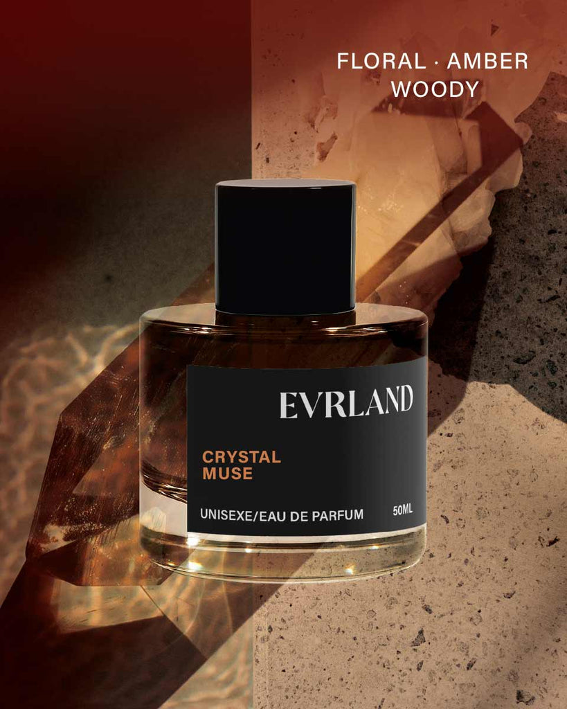 Perfume bottle labeled 'Evrland Crystal Muse' with a dark label on a textured surface.